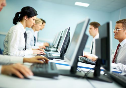 Office with white collar workers working on computers